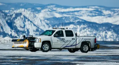 Snow operations truck at Rocky Mountain Airport (BJC) with mountains in background