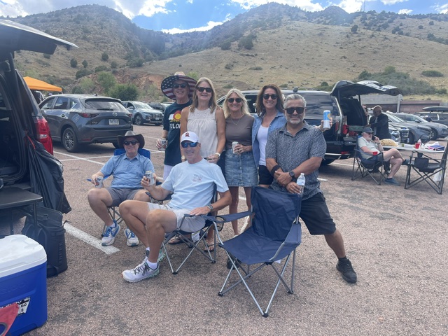 Smiling group of travelers gathered at Red Rocks