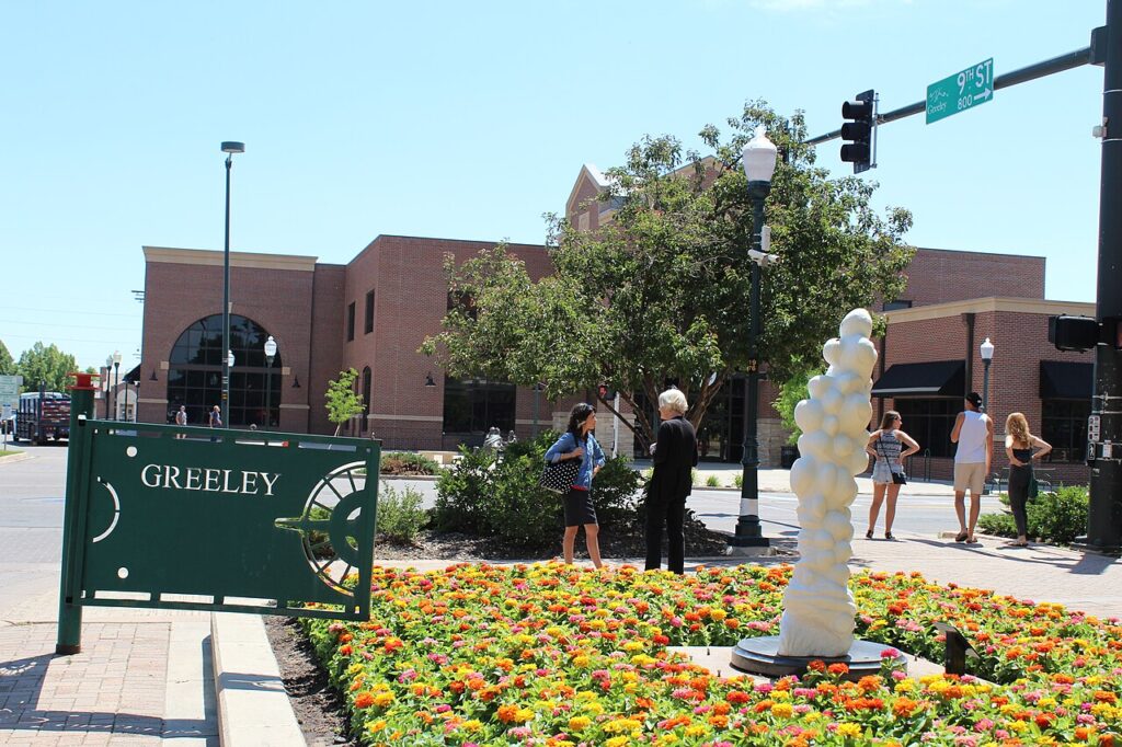 Downtown Greeley 9th Street Plaza — Private Airport Transportation | Town to Mountain Express Denver Airport Shuttle People and flower gardens at Greeley’s downtown 9th Street Plaza